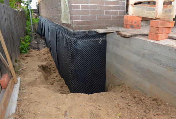 SJ Waterproofing Pros technician performing targeted Wet Basement Repair assessment in Mogadore, OH